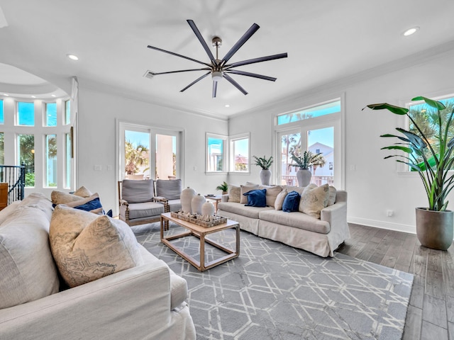 living area with recessed lighting, wood finished floors, visible vents, baseboards, and ornamental molding