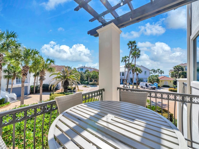 balcony featuring outdoor dining space and a residential view