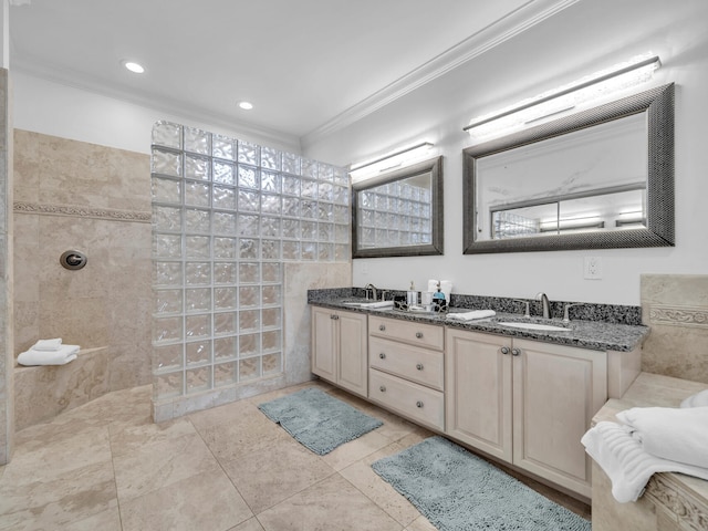 full bathroom with a walk in shower, ornamental molding, a sink, and tile walls