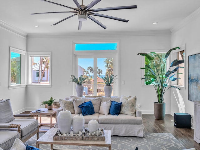 living area featuring a ceiling fan, crown molding, baseboards, and wood finished floors