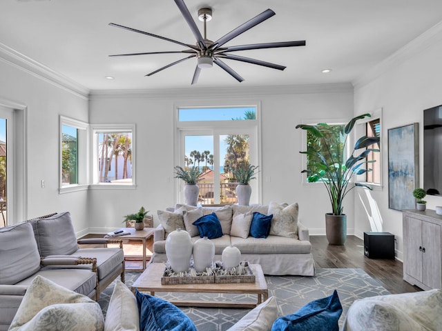 living area featuring a ceiling fan, baseboards, ornamental molding, and wood finished floors