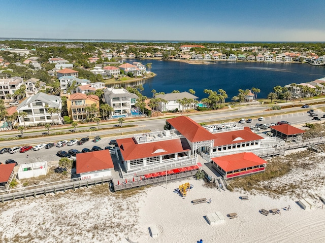 drone / aerial view featuring a residential view and a water view