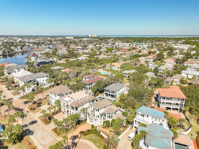 drone / aerial view featuring a residential view and a water view