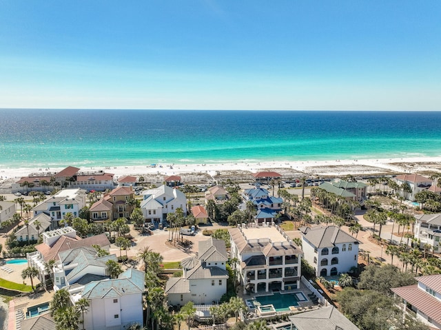 birds eye view of property featuring a water view, a residential view, and a beach view