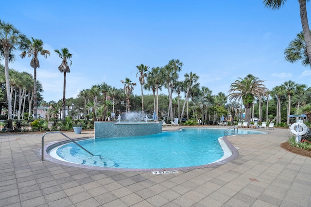 community pool featuring a patio area and fence