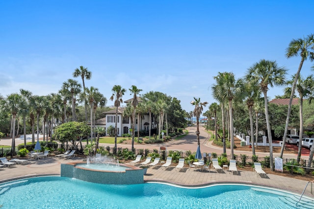 view of swimming pool featuring fence and a patio