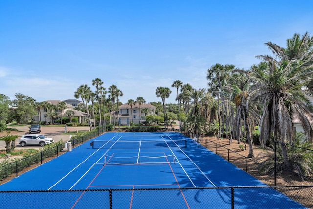 view of sport court featuring fence