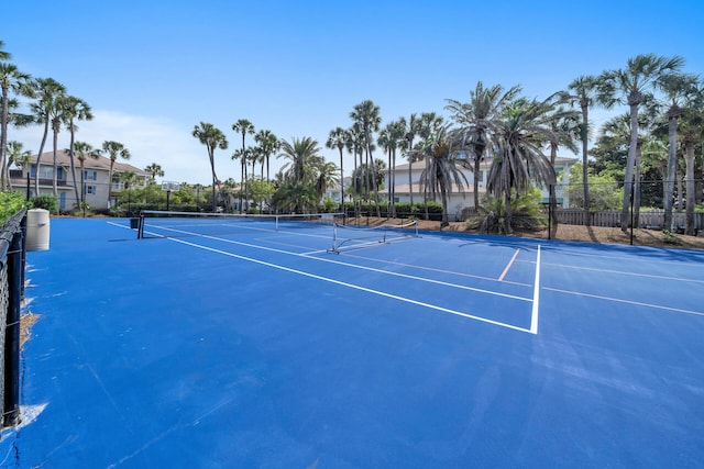 view of tennis court featuring fence