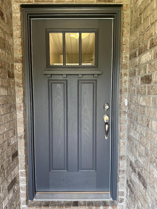 entrance to property with brick siding