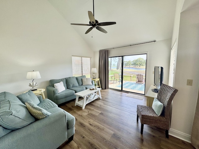 living area with baseboards, high vaulted ceiling, ceiling fan, and wood finished floors