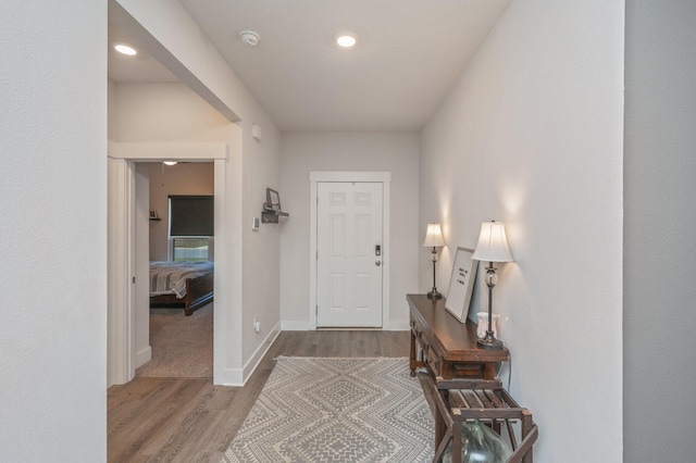 entrance foyer with recessed lighting, wood finished floors, and baseboards