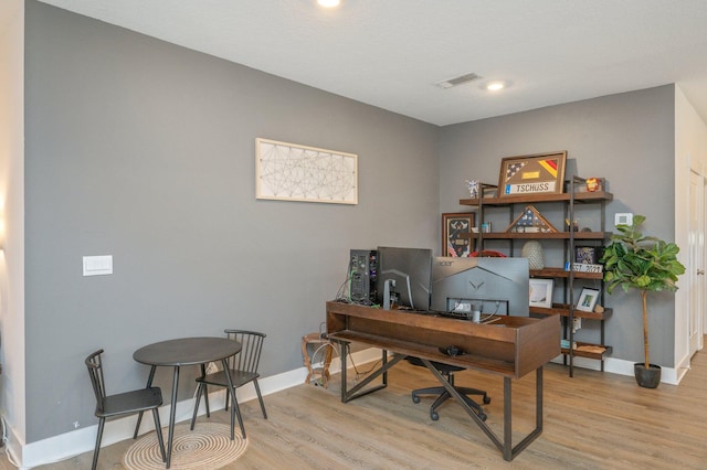 office area featuring light wood-type flooring, visible vents, baseboards, and recessed lighting