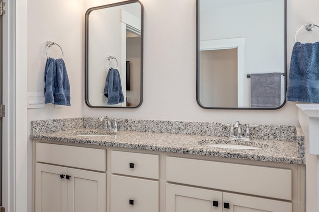 bathroom with double vanity and a sink