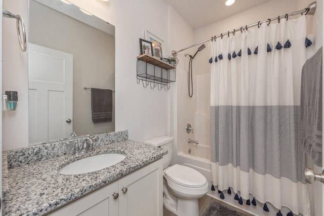 bathroom featuring toilet, shower / bathtub combination with curtain, and vanity