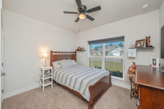 bedroom with baseboards, a ceiling fan, and light colored carpet