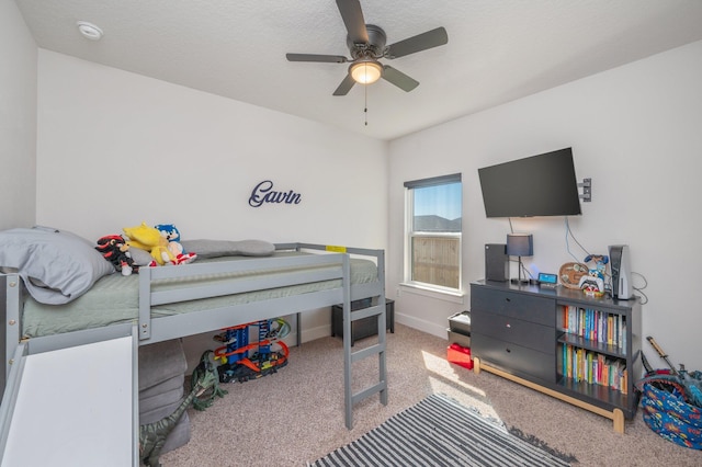 bedroom with ceiling fan, baseboards, and carpet flooring