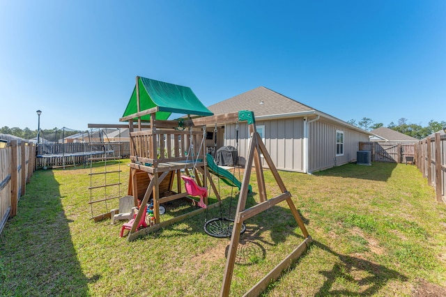 view of jungle gym featuring a fenced backyard, a trampoline, and a lawn