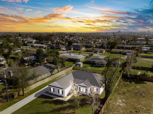 aerial view at dusk featuring a residential view