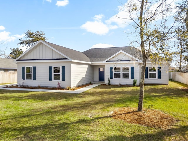 single story home with roof with shingles, board and batten siding, a front yard, and fence