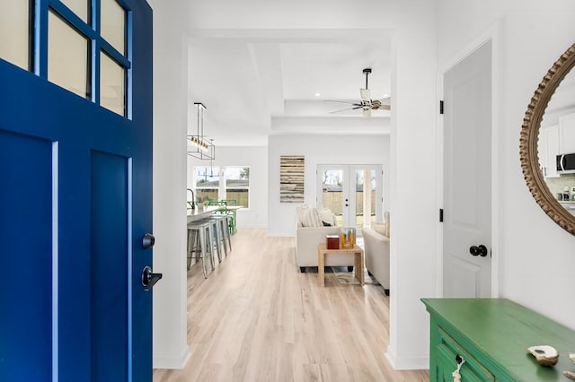 foyer with ceiling fan, french doors, recessed lighting, and light wood-style floors