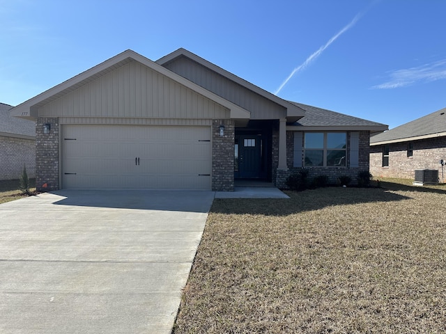 single story home featuring concrete driveway, an attached garage, cooling unit, a front lawn, and brick siding