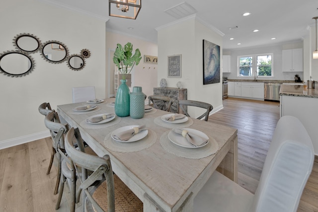 38 Basswood Dr, Santa Rosa Beach, FL 32459 - dining area with ornamental molding, light wood-style flooring, and baseboards