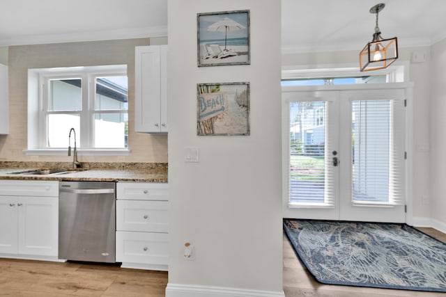 38 Basswood Dr, Santa Rosa Beach, FL 32459 - kitchen with a sink, white cabinets, french doors, stainless steel dishwasher, and crown molding