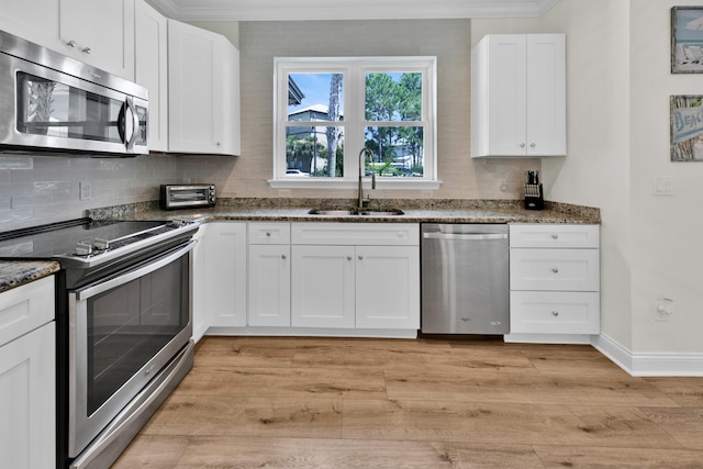 38 Basswood Dr, Santa Rosa Beach, FL 32459 - kitchen with stone counters, stainless steel appliances, a sink, and light wood finished floors