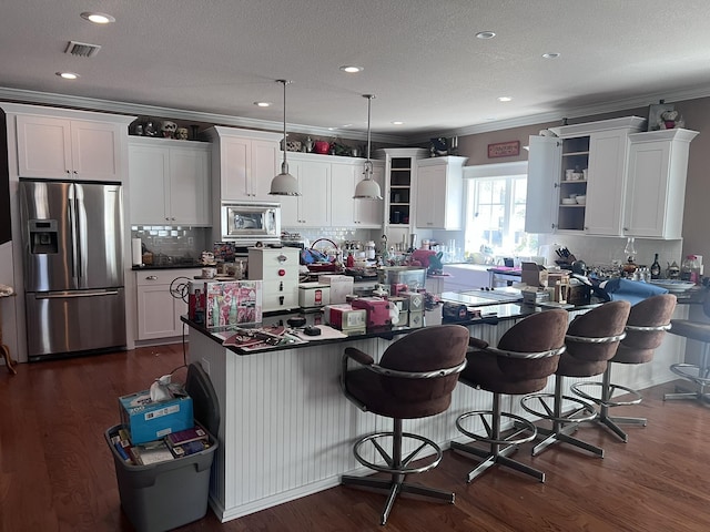 kitchen with dark wood finished floors, open shelves, visible vents, and stainless steel appliances