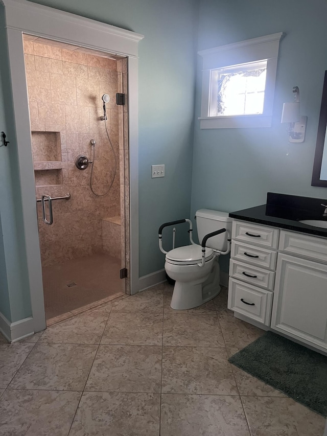 full bath with baseboards, toilet, a stall shower, and vanity