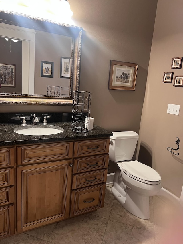 bathroom featuring vanity, toilet, and tile patterned flooring