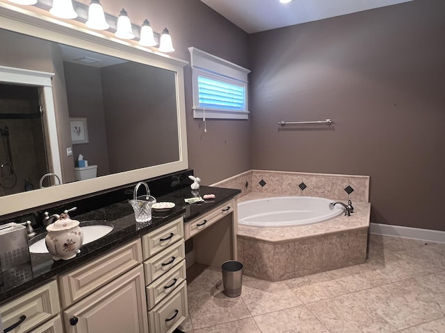 bathroom featuring vanity, a garden tub, baseboards, and tile patterned floors