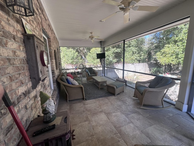 unfurnished sunroom featuring ceiling fan