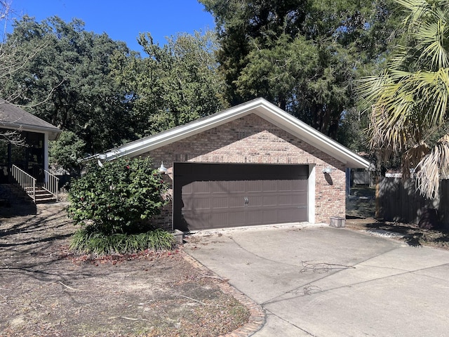 garage featuring concrete driveway