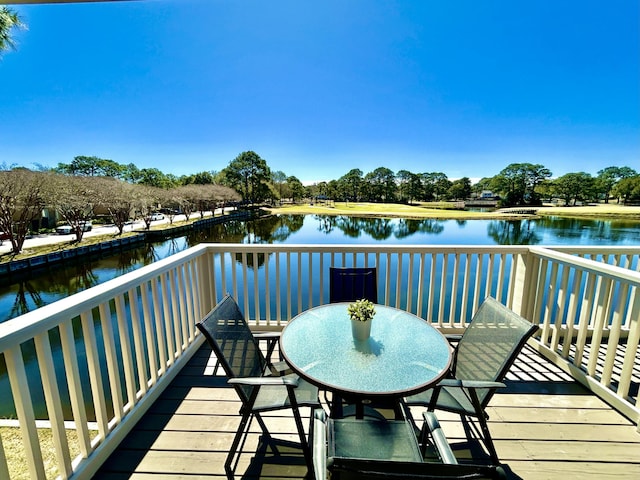 wooden terrace featuring a water view