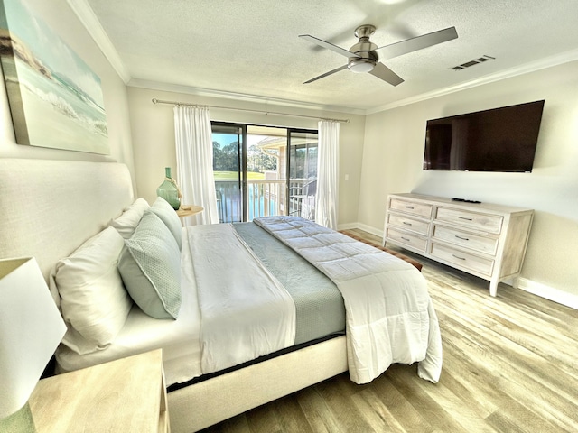 bedroom with visible vents, wood finished floors, access to outside, a textured ceiling, and crown molding