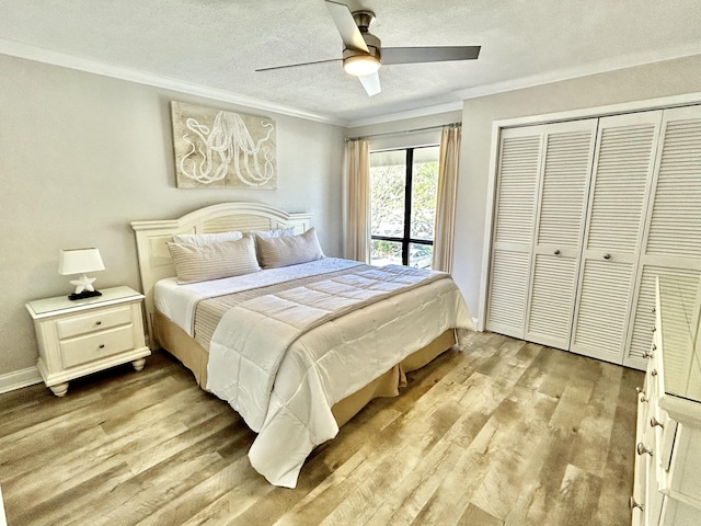 bedroom with light wood-type flooring, a closet, crown molding, and a textured ceiling