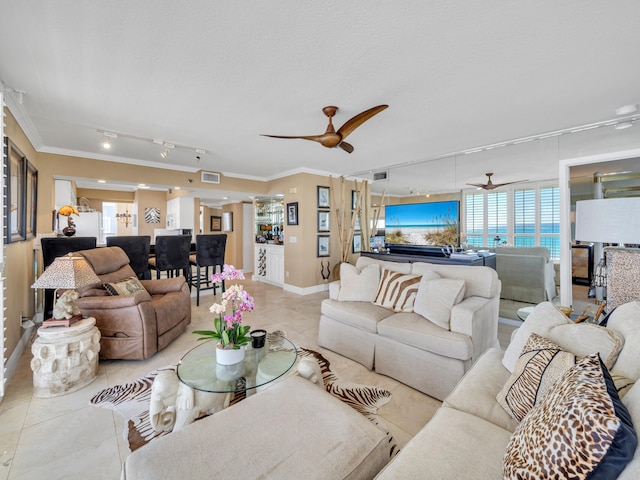 living room with light tile patterned floors, baseboards, ceiling fan, rail lighting, and crown molding