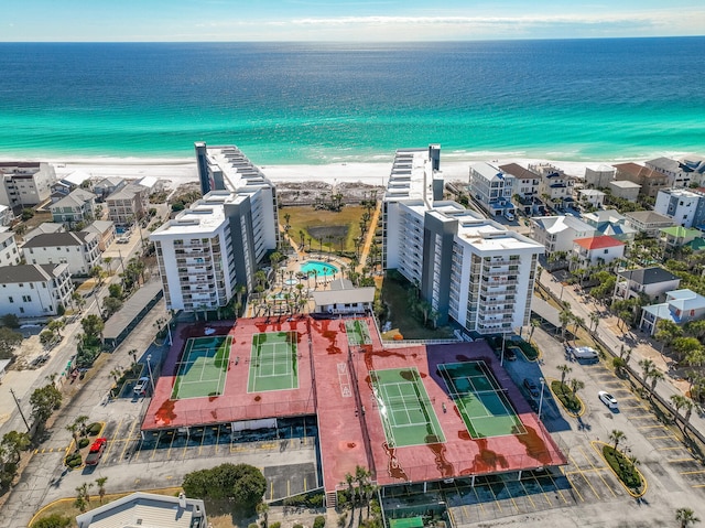 drone / aerial view featuring a water view and a view of the beach