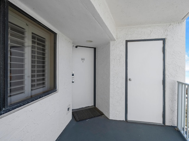 doorway to property with stucco siding