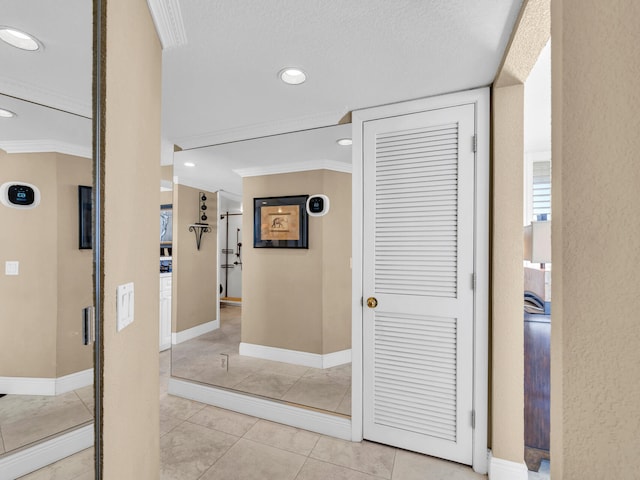 corridor featuring ornamental molding, recessed lighting, light tile patterned flooring, and baseboards