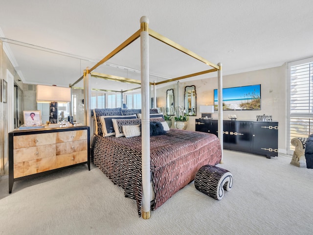 bedroom with crown molding and carpet flooring