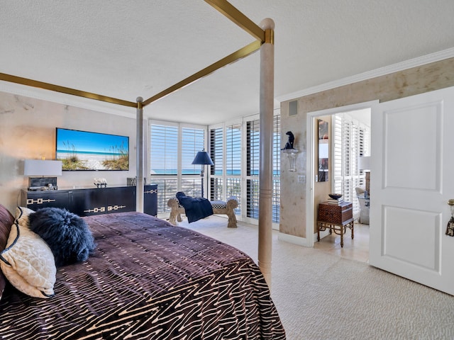 carpeted bedroom with a textured ceiling, expansive windows, and crown molding