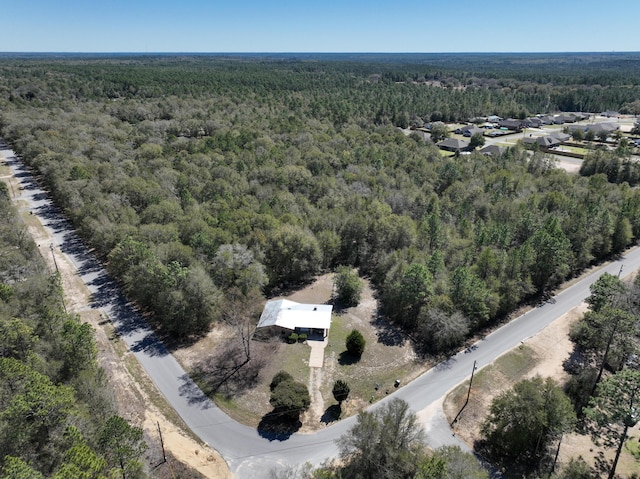 drone / aerial view with a wooded view