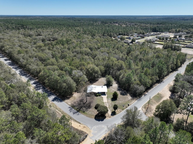 bird's eye view featuring a wooded view