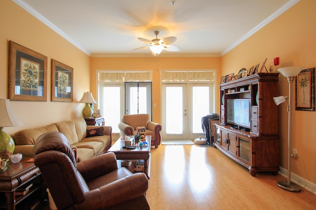 living room featuring light wood finished floors, ceiling fan, french doors, and crown molding