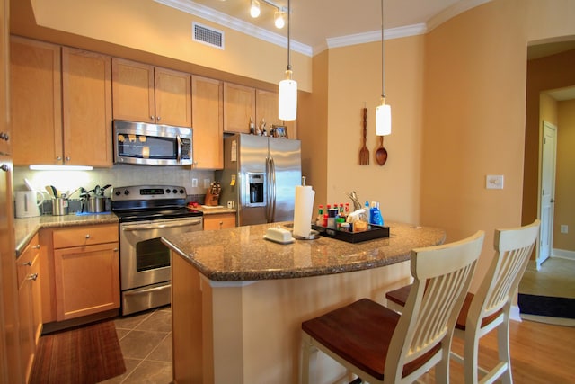 kitchen with stainless steel appliances, visible vents, ornamental molding, dark stone counters, and tasteful backsplash