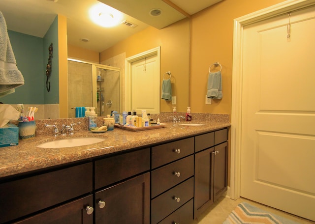 full bathroom with tile patterned floors, a sink, visible vents, and a shower stall