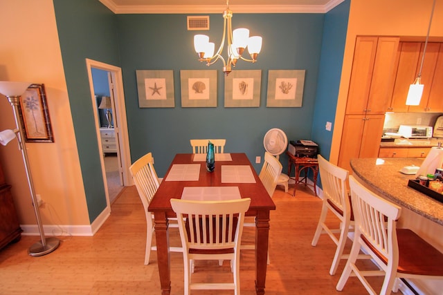 dining space with crown molding, light wood finished floors, visible vents, a chandelier, and baseboards