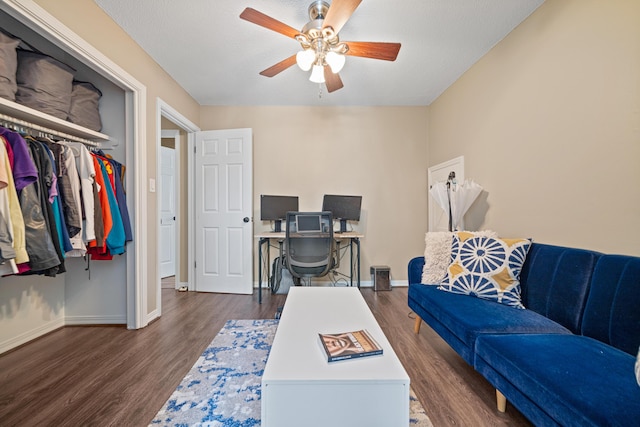 office featuring a ceiling fan, baseboards, and wood finished floors